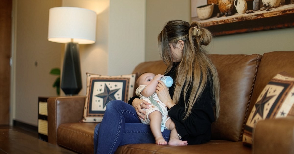 A mother feeding her baby at home