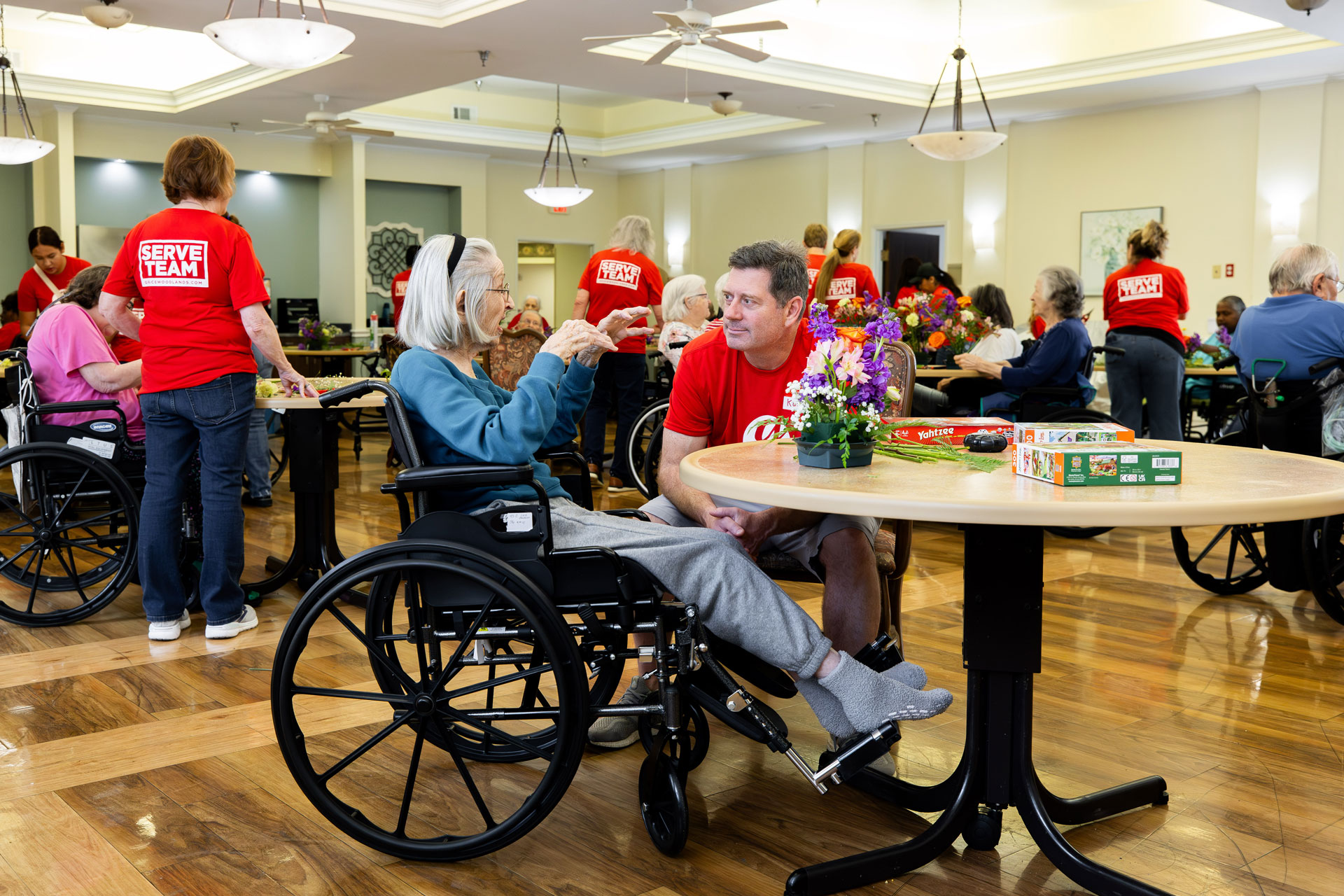 Grace Woodlands volunteers spending time with older adults during a community outreach