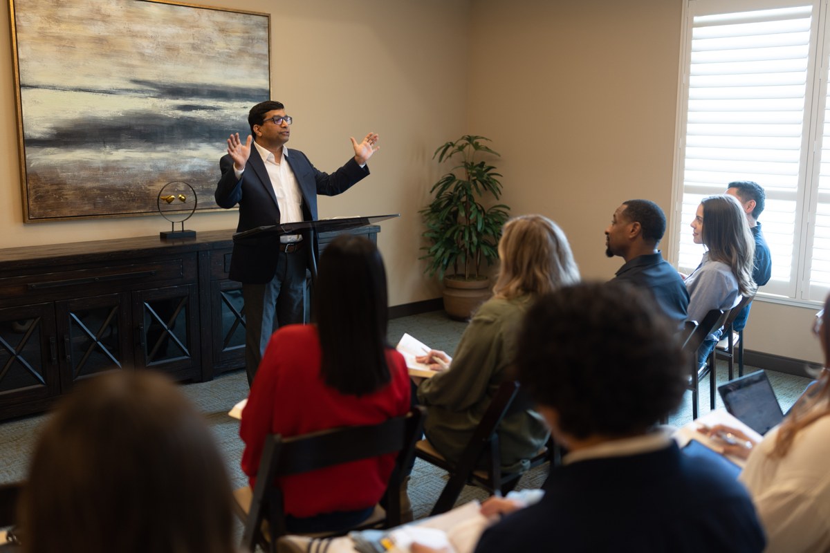 A teacher speaking to a small group gathered indoors